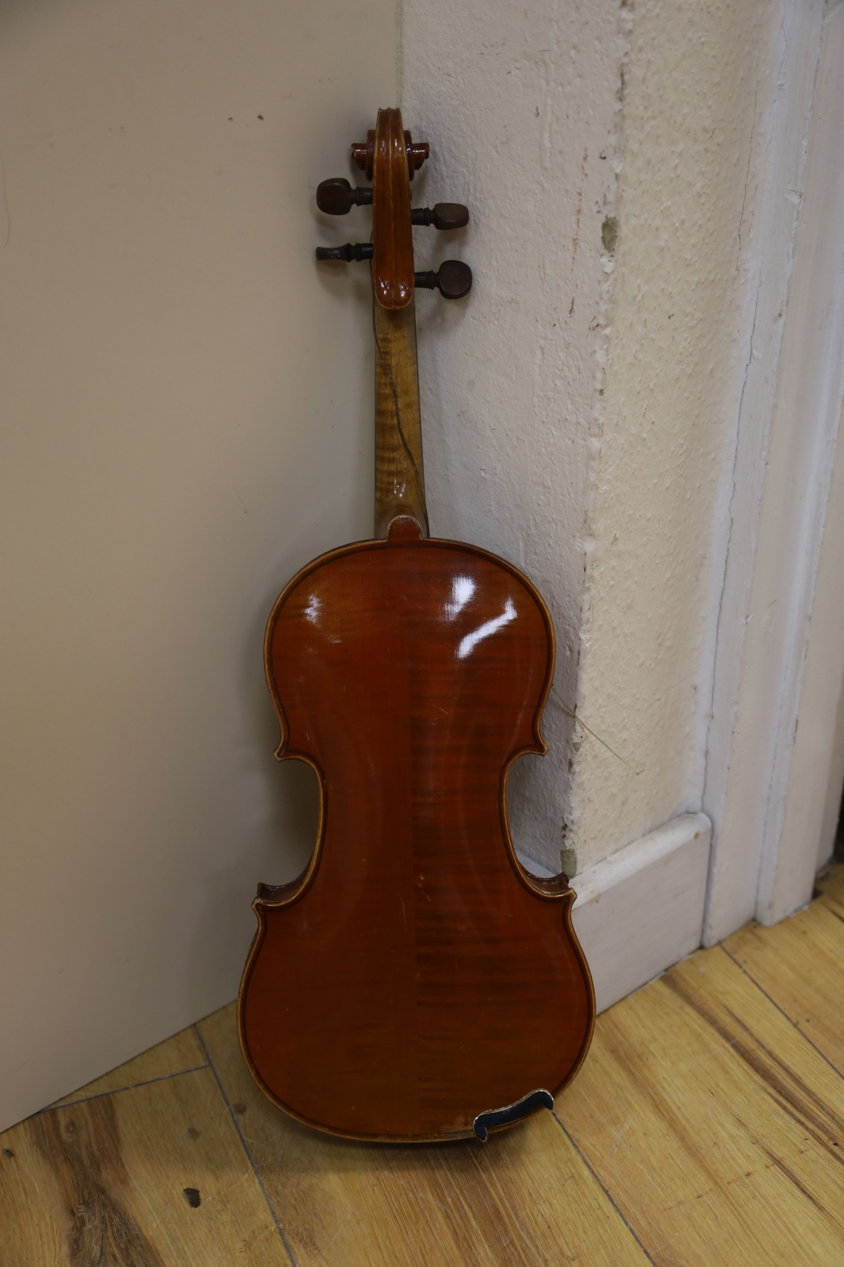 A Stradivarius copy violin and two bows and another bow, both cased, backs 33cm and 30cm